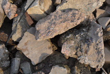 Trash, construction waste, broken walls of buildings and structures. Red, cement bricks scattered all over the background.