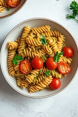 Colorful pasta dish with fresh cherry tomatoes and herbs garnish
