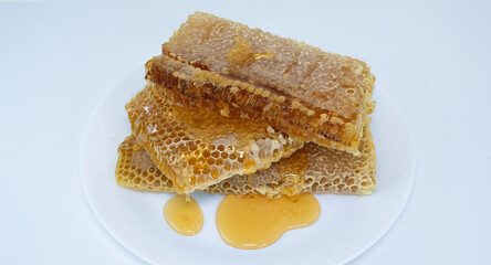 honey flowing over natural honeycombs
