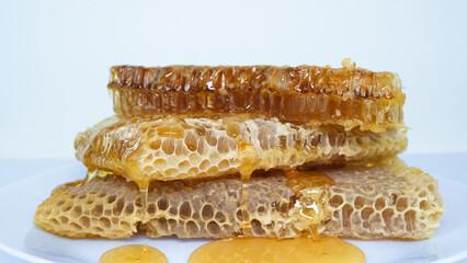 honey flowing over natural honeycombs