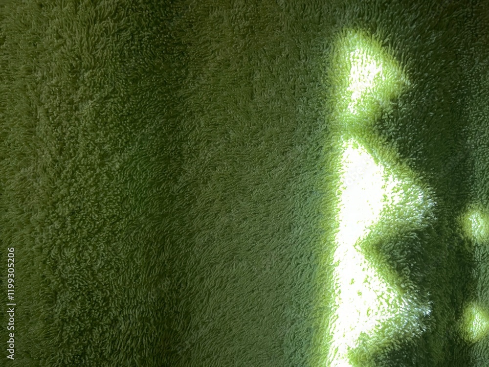 Poster subtle sunlight creating geometric patterns on textured green towel fabric, perfect for abstract designs, background concepts, or natural themes