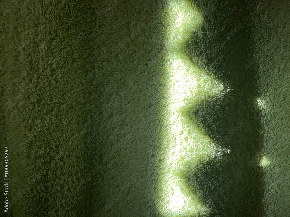 Poster subtle sunlight creating geometric patterns on textured green towel fabric, perfect for abstract des