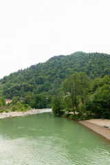 mountainous landscape in Georgia with overgrown green cliffs of the Caucasus Mountains in summer