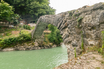 Obraz premium mountainous landscape in Georgia with overgrown green cliffs of the Caucasus Mountains in summer