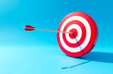 An arrow strikes the center of a red and white target against a bright blue backdrop, symbolizing accuracy and skill