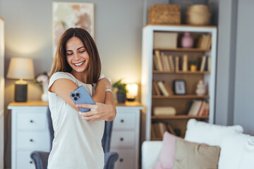 Smiling Woman Taking Selfie With Smartphone In Cozy Home Setting