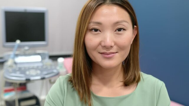 Portrait of asian female obstetrician gynecologist in office during work. Professional and responsible doctor working in a leading clinic of city.