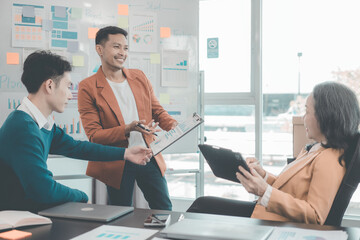 Group of young Asian businessmen Celebrate office startup success Brainstorming meeting of creative...