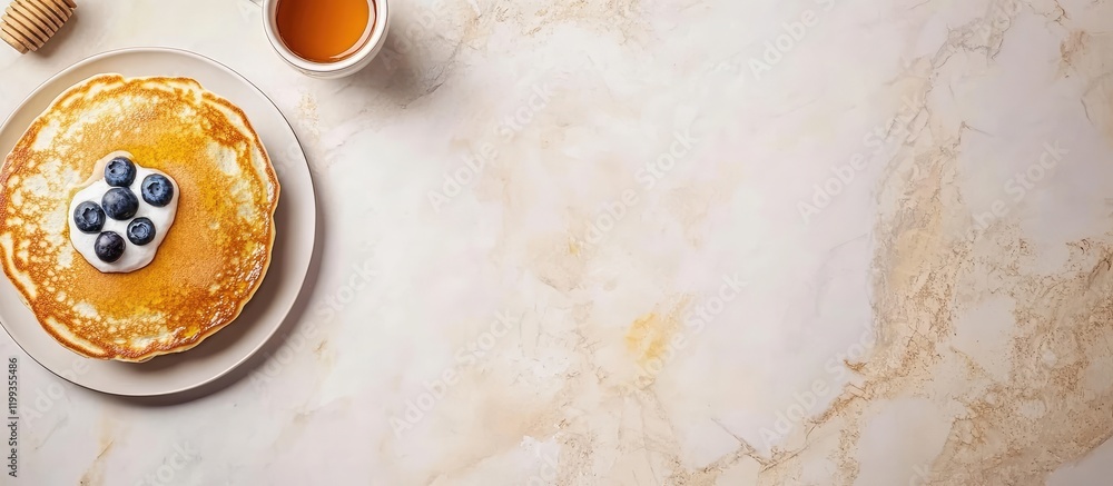 Poster fluffy pancakes topped with fresh blueberries and honey accompanied by a coffee cup on a marble coun