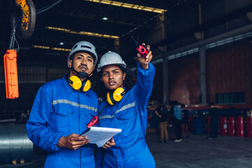Foreman or worker work at factory site check up machine or products in site.
