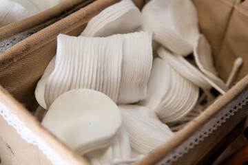Cotton pads for removing makeup are in a basket photographed close-up..Sponge cotton pad for makeup artist..