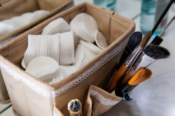 Cotton pads for removing makeup are in a basket photographed close-up..Sponge cotton pad for makeup artist..
