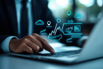 A business professional analyzing data on a laptop with digital graphics.