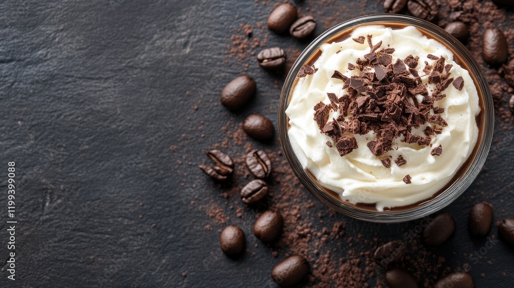 Poster overhead view of creamy coffee dessert topped with chocolate on dark slate background surrounded by 