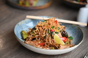 stir fried noodles with vegetables, chicken, tofu, serving  asia food