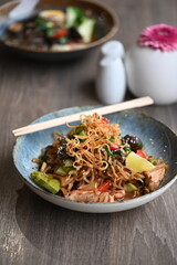 stir fried noodles with vegetables, chicken, tofu, serving  asia food