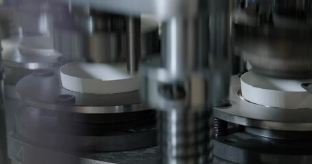 Detailed view of automated machinery in a paper cup manufacturing factory, showcasing industrial processes and precision engineering in action