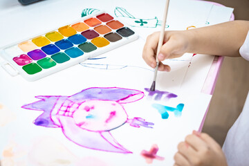  child painting a picture with school supplies, preschool child painting, child drawing a rainbow, child doing homework.
