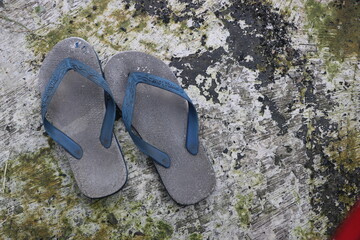 A pair of worn and weathered flip-flops
