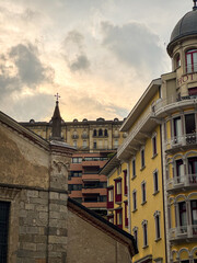 Fototapeta premium Bright Lugano city western European buildings layered behind each other in early sunset, Switzerland