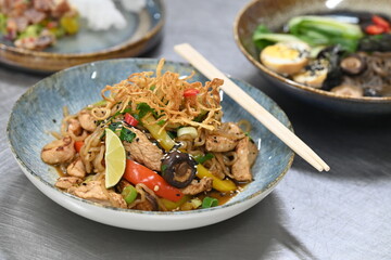 A close-up shot of a healthy, vibrant dish featuring Konjac noodles with tender chicken and a variety of fresh vegetables.