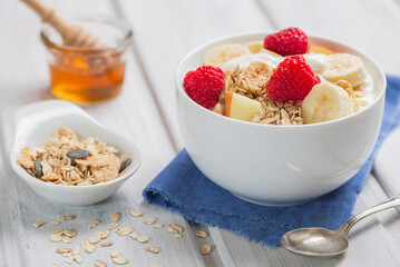 Muesli with flakes and fresh fruits, healthy delicious breakfast