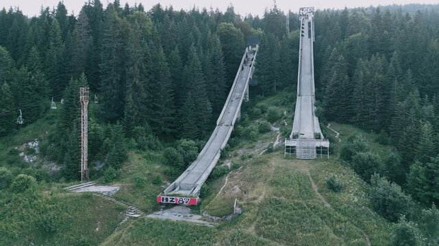 Igman Ski Jump &ndash; Aerial View of Historic Olympic Venue - Stunning aerial footage of the Igman ski jump, a historic Olympic venue surrounded by breathtaking mountain scenery. The video showcases the ic