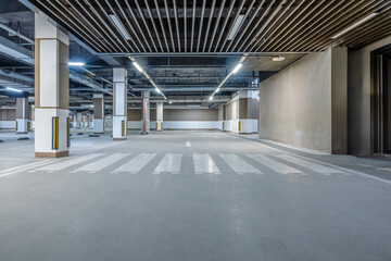 Empty parking lot with crosswalk and many pillars
