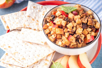 Traditional Charoset for Passover Seder and Pesah holiday, Jewish fruit salad haroset with diced apple, wine, cinnamon, nuts