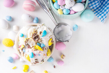 Easter egg ice cream, bowl of vanilla gelato with crushed chocolate mini eggs, sweet dessert treat...