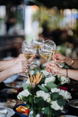 Friends toasting with wine glasses at a beautifully decorated table, celebrating special moments