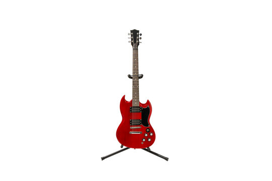 A red guitar stands on a stand. Guitar on a transparent background. The guitar is not used. - Powered by Adobe