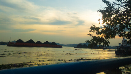 Kalimantan Indonesia - Afternoon view at sea and a barge transporting coal