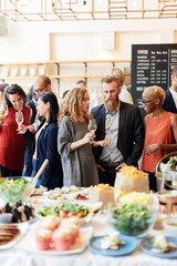 Diverse group at a social event, enjoying drinks and conversation. Men and women of various...
