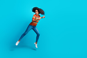 Photo of crazy running active funny girl curly hair wearing casual outfit looking empty space scared isolated on blue color background
