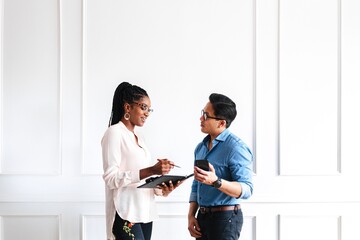 A professional woman and man discussing work, business conversation. Professional attire, business...