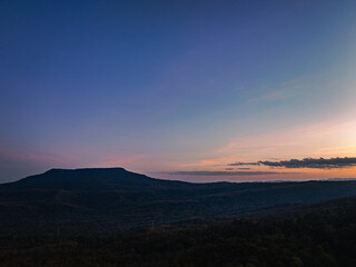 .aerial view A beautiful sunset paints the sky in vivid shades of orange .and red over a deciduous forest..Colorful leaves when the season comes to bloom in the big forest.