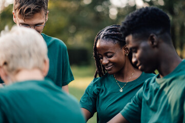 Group of diverse volunteers standing together in a park