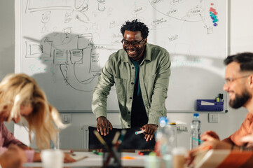 Smiling teacher leading a brainstorming session with students