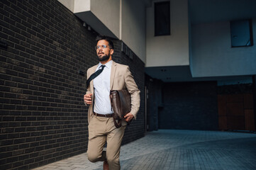 Businessman running late for work in urban city