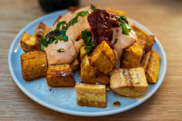 fried bananas or plantains with savory hot sauces served as tapas in a cafe in Malaga, Spain