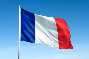 Waving France flag, national symbol, blue sky