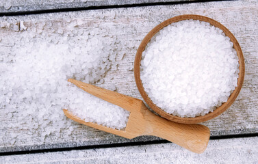Sea salt on a wooden table. Coarse sea salt for cooking.