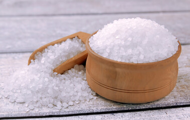 Sea salt on a wooden table. Coarse sea salt for cooking.