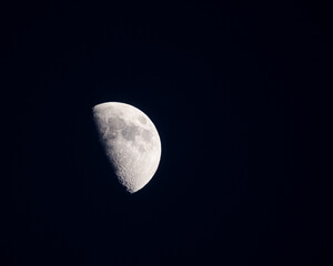 The first quarter moon in early January of 2025. Many of the moons maria, or seas, and craters are visible. Also visible are the Apollo 11, 16, and 17 landing sites and the Mare Tranquillitatis.