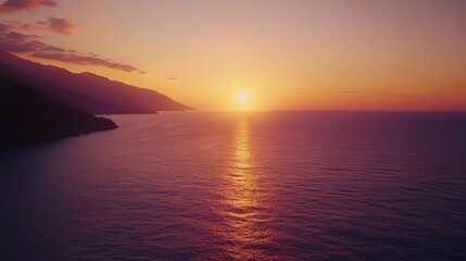 Fototapeta premium Coastal Sunset Over Mountains and Ocean Water