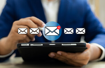 New email notification alerts concept for Digital marketing business communication through virtual inbox and internet technology as Business people use tablet with emails on a virtual screen