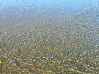 Sea gentle waves on sandy beach