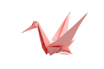 Elegant origami crane made from pink paper displayed on a white surface during artistic craft session