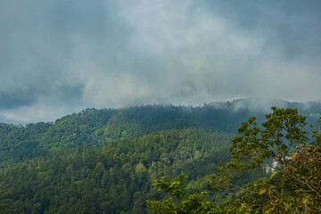 The stunning view of the sun set  from a tourist's standpoint with a foggy hill and a background of a golden sky in National Park, Thailand. Rainforest. Bird's eye view. Aerial view.